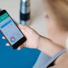 woman holding phone with weight loss app
