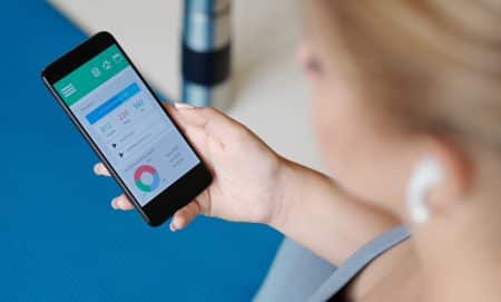 woman holding phone with weight loss app